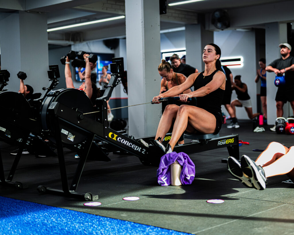 Person doing kettlebell squats during a high-energy group workout at F45 studio